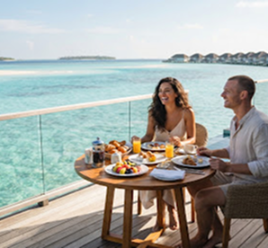 Couple enjoying seaside breakfast